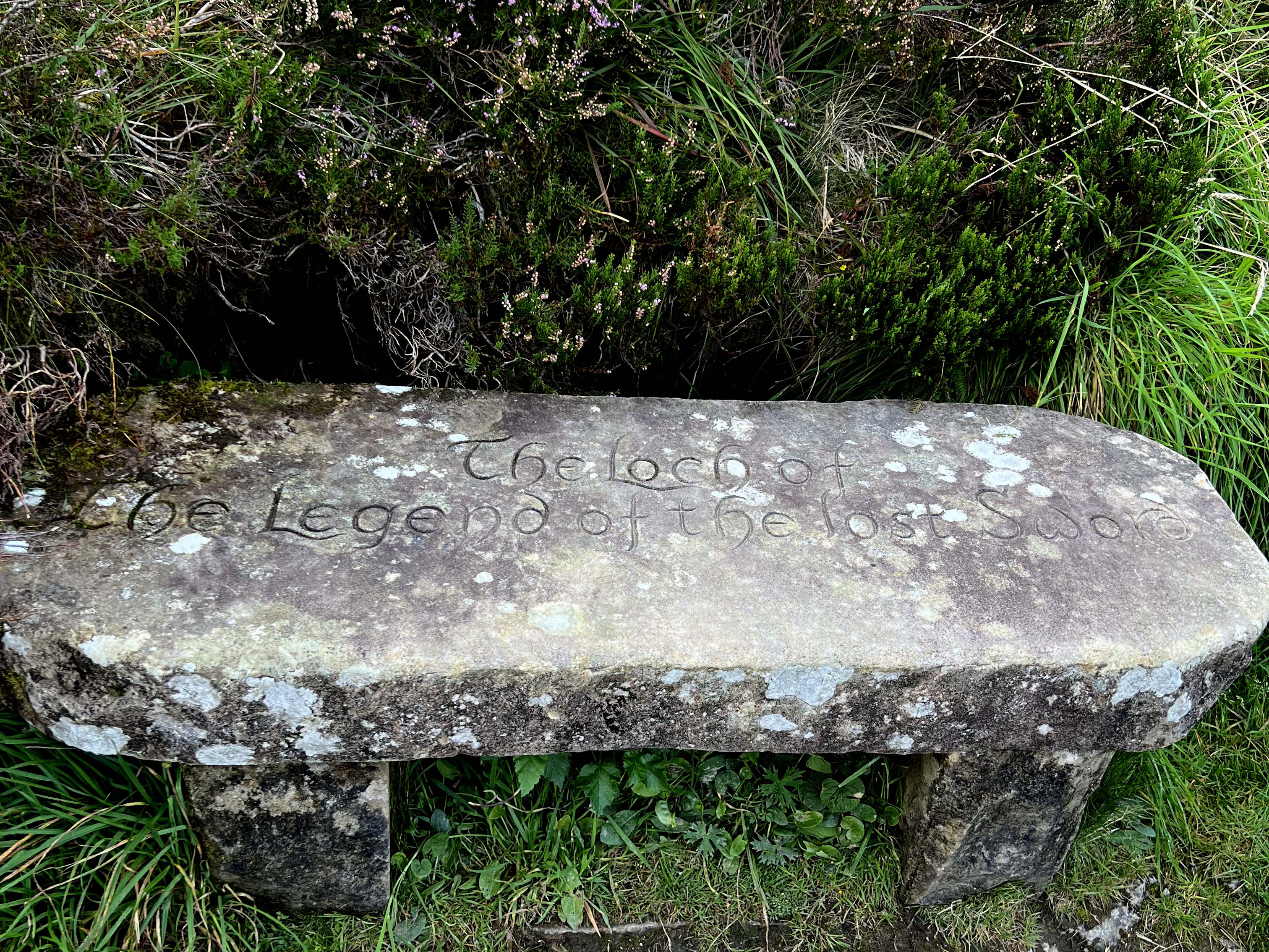 a stone bench with celtic writing